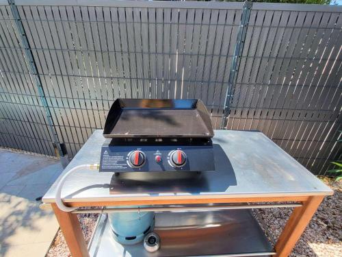 a grill sitting on top of a table at Pleasant detached villa with private swimming pool for 6 people in Lauris - Luberon. in Lauris