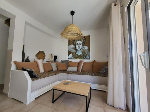 a living room with a couch and a table at Pleasant detached villa with private swimming pool for 6 people in Lauris - Luberon. in Lauris