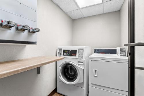 a laundry room with a washer and dryer at Days Inn by Wyndham Sioux Falls in Sioux Falls