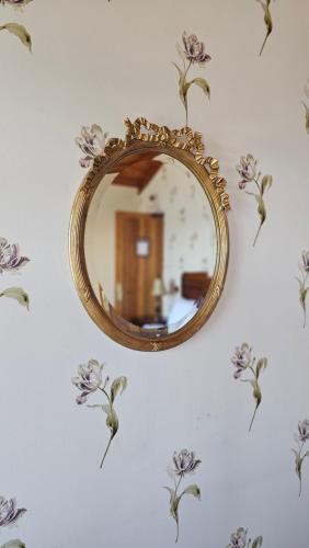 a mirror on a wall with flowers on it at Hotel Boutique Domus Mare in Viña del Mar