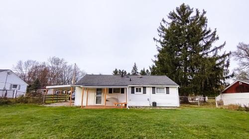 a small white house in a field of grass at Entire House in Twinsburg in Twinsburg