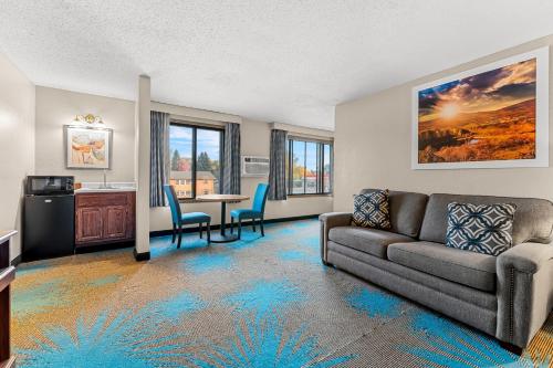 a living room with a couch and a table at Days Inn by Wyndham Sioux Falls in Sioux Falls