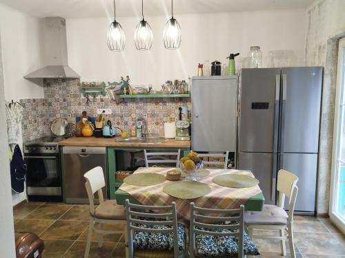 a kitchen with a table and a refrigerator at Villa Evetes in Jablonov nad Turnou