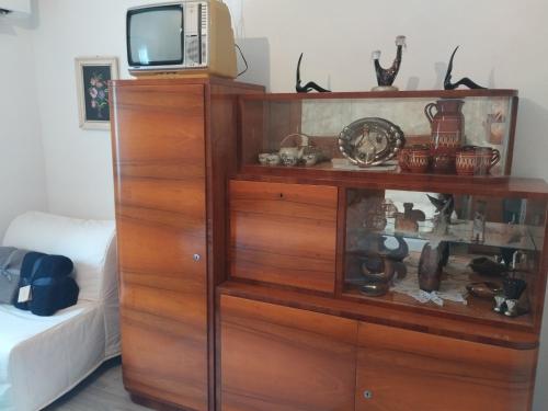 a wooden dresser with a tv on top of it at Villa Evetes in Jablonov nad Turnou