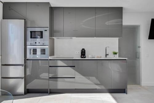 a kitchen with stainless steel cabinets and appliances at CAMINITO REY & BANDERAS SPA Relax in Carratraca
