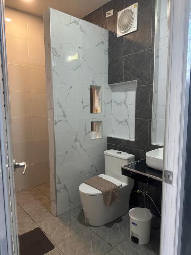 a bathroom with a toilet and a sink at J House Has Love in Sukhothai