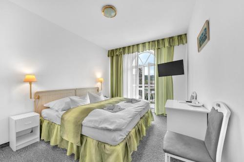 Postel nebo postele na pokoji v ubytování Hotel Ferdinand