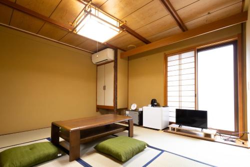 a living room with a bench and a large window at Fukunosumika - Vacation STAY 79527v in Nanto