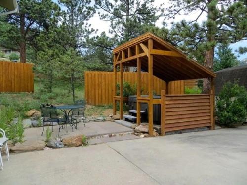 a wooden gazebo with a table and a table at Bear House - EV #3073 in Estes Park