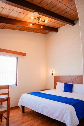 Una cama o camas en una habitación de Hotel Del Angel, Apizaco