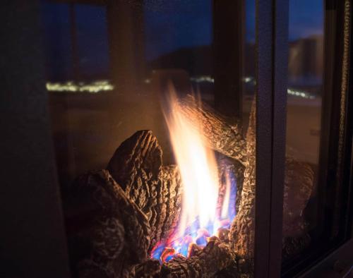 a fire in a stove in a window at Luxury Lookout Hood Canal Vacation Rental in Union