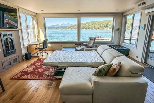 a living room with a couch and a large window at Luxury Lookout Hood Canal Vacation Rental in Union
