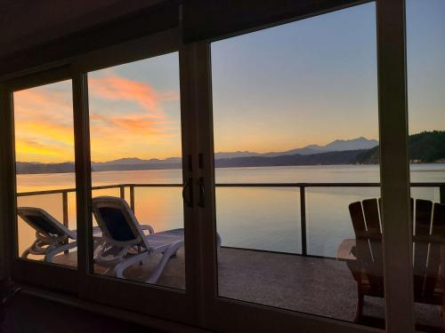 a room with two chairs and a view of the water at Luxury Lookout Hood Canal Vacation Rental in Union