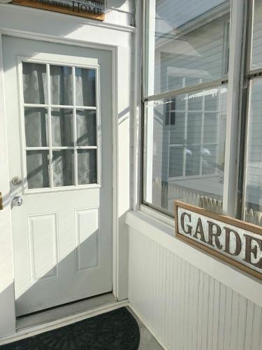 a white door with a sign in front of a garage at Sunshine Room by harbor downtown beach I-95&Train in Stamford