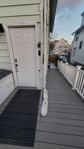 a door to a house with a dog bed next to it at Sunshine Room by harbor downtown beach I-95&Train in Stamford