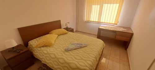 a bedroom with a bed with two towels on it at Apartament Alina Et 1 in Mangalia