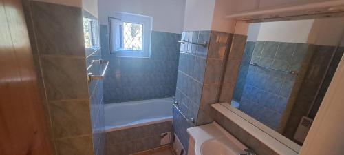 a bathroom with a shower and a tub and a sink at Apartament Alina Et 1 in Mangalia