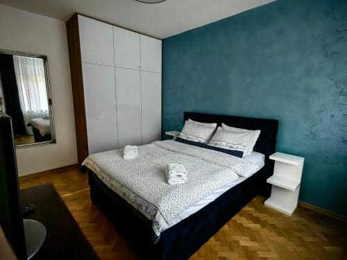 a bedroom with a bed with two towels on it at Apartman Cetkovic in Belgrade