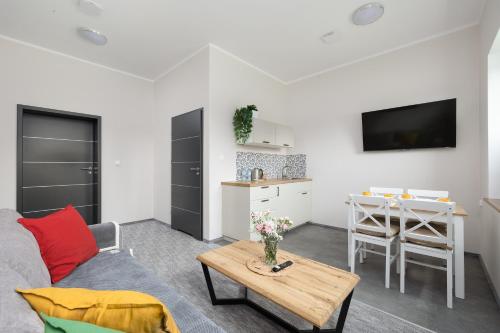 a living room with a couch and a table at KAJNET Resko in Resko