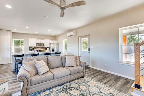 a living room with a couch and a kitchen at Stocked Fishing Ponds Texas Getaway with Cows! in Bonham