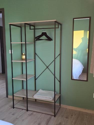 a glass shelf in a room with a mirror at La maison d'Achille in Nassogne