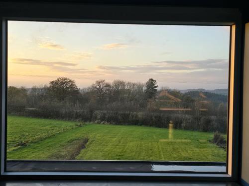 a view of a field from a window at La maison d'Achille in Nassogne