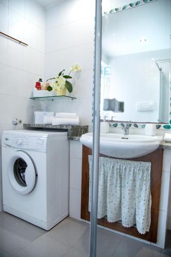a bathroom with a washing machine and a sink at Casa Petito - Casa Vacanze in Giugliano in Campania