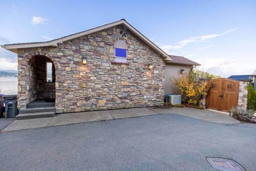 a stone building with a driveway in front of it at Luxury Lookout Hood Canal Vacation Rental in Union