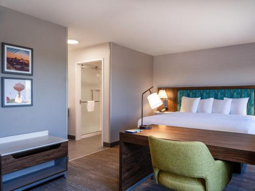 a hotel room with a bed and a desk and a chair at Hampton Inn & Suites Boise-Meridian in Meridian