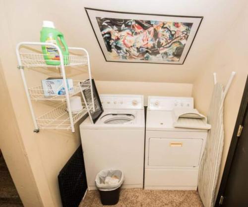 a small laundry room with a washer and dryer at Schillhaus Lvl 1 in Louisville