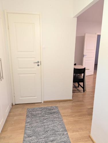 a room with a white door and a rug at 20 - Nice apartment in Kemi City Centre, free parking! in Kemi