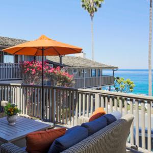a patio with a table and an umbrella on a balcony at Scripps Inn in San Diego