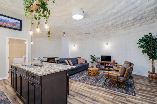 a kitchen and living room with a couch and a counter at Secluded LUX Bunker Hot Tub, Views & Trails in Stanley