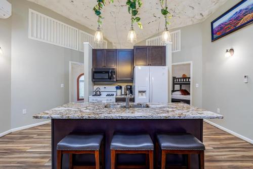 a kitchen with a large island with bar stools at Secluded LUX Bunker Hot Tub, Views & Trails in Stanley