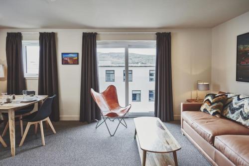 a living room with a couch and a table at Taynuilt Inn Apartments in Taynuilt