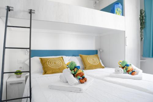 a bedroom with two bunk beds with stuffed animals on them at Club del Sole Romagna Family Resort in Riccione