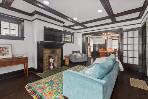a living room with a blue couch and a fireplace at Sweet Retreat in Frankfort