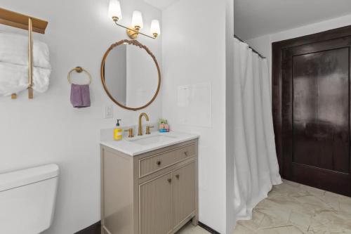 a bathroom with a sink and a mirror and a toilet at Sweet Retreat in Frankfort
