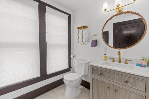 a bathroom with a toilet and a sink and a mirror at Sweet Retreat in Frankfort