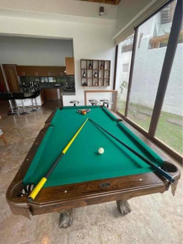 a green pool table with a ball on top of it at Casa VIP con la mejor vista de Lomas de Cocoyoc in Texcalpan