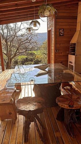 a patio with a table and chairs on a deck at Sítio vale das pedras in Barracão