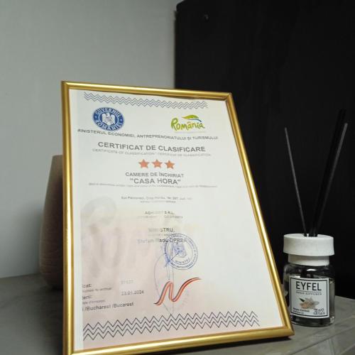 a framed certificate of equivalence with a bottle of supplements at CASA Hora in Pîrcovaci