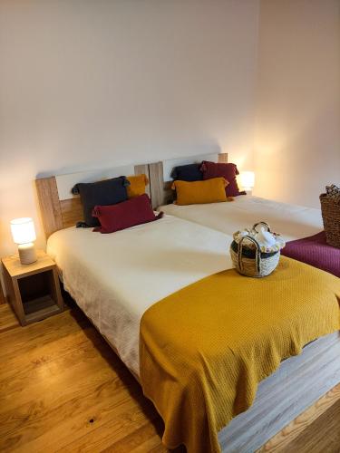 two beds sitting next to each other in a room at Casa de Campo Vale do Ceira in Góis