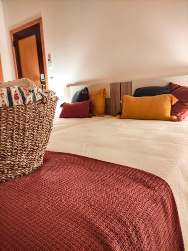 a bedroom with two beds with colorful pillows on them at Casa de Campo Vale do Ceira in Góis