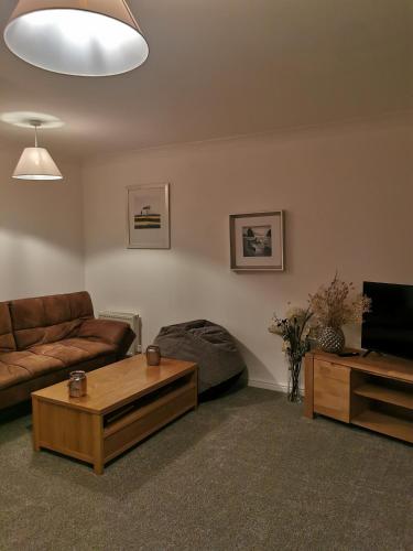 a living room with a couch and a coffee table at Sun Gardens Retreat- can sleep 10 with 4 Double Beds & 2 sofa beds in Stockton-on-Tees