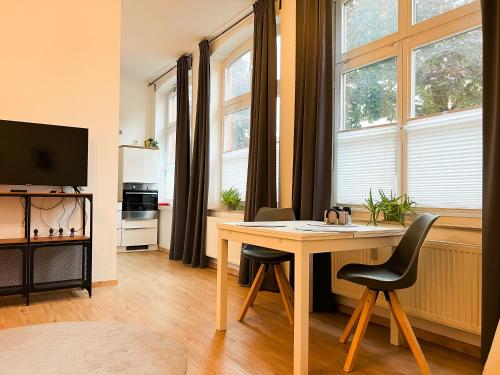 a living room with a table and two chairs at Qonroom - as individual as you - Oeynhausen City in Bad Oeynhausen