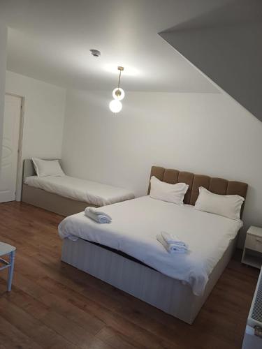 a bedroom with a large bed with white sheets at CASA Hora in Pîrcovaci