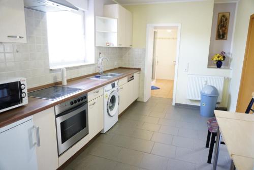 a kitchen with a sink and a dishwasher at VIK Apartement in Kolonie Eichenweiler