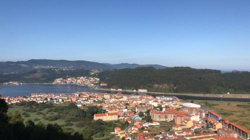 a view of a town with a river and a city at Estudio 33 in San Juan de la Arena