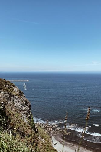 a view of the ocean from a cliff at Estudio 33 in San Juan de la Arena